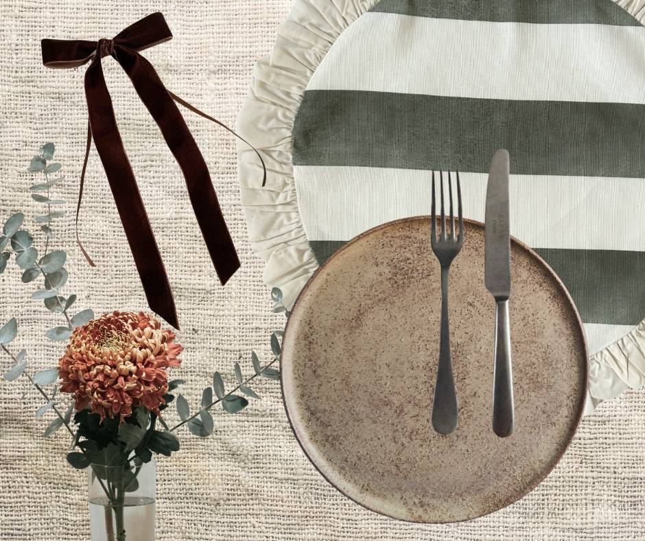Sage Riviera striped ruffled linen placemat styled with rustic stoneware, velvet bow, and eucalyptus for a natural and grounded table setting.